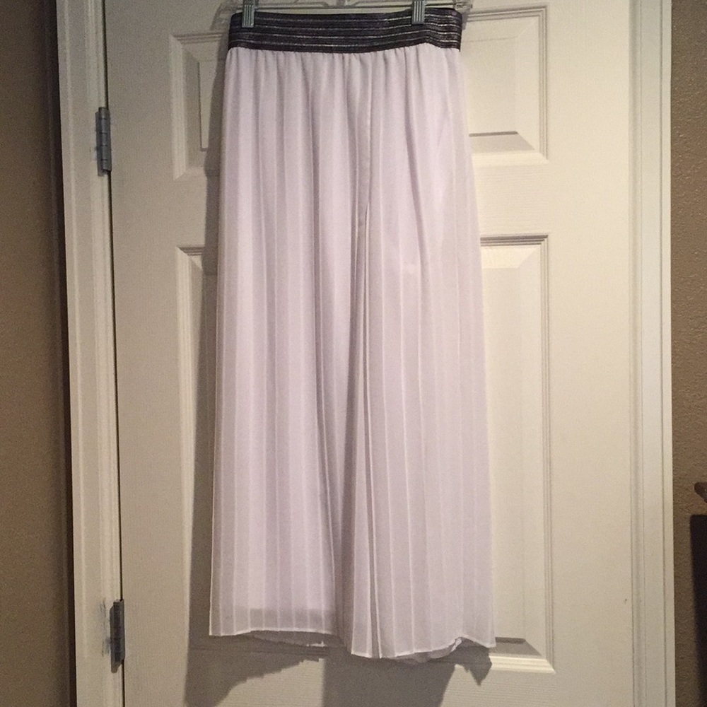 White pants with black and silver waistband